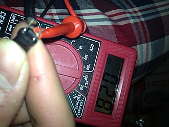Real 4-band axial lead through-hole inductor showing lead wires and colored bands